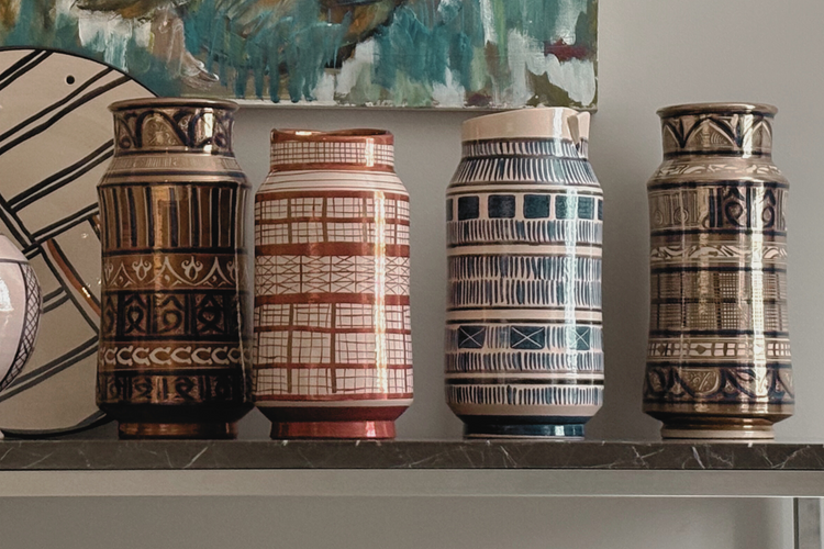 Handmade ceramic bowls, plates, and vases with tin glaze and lustreware finish.