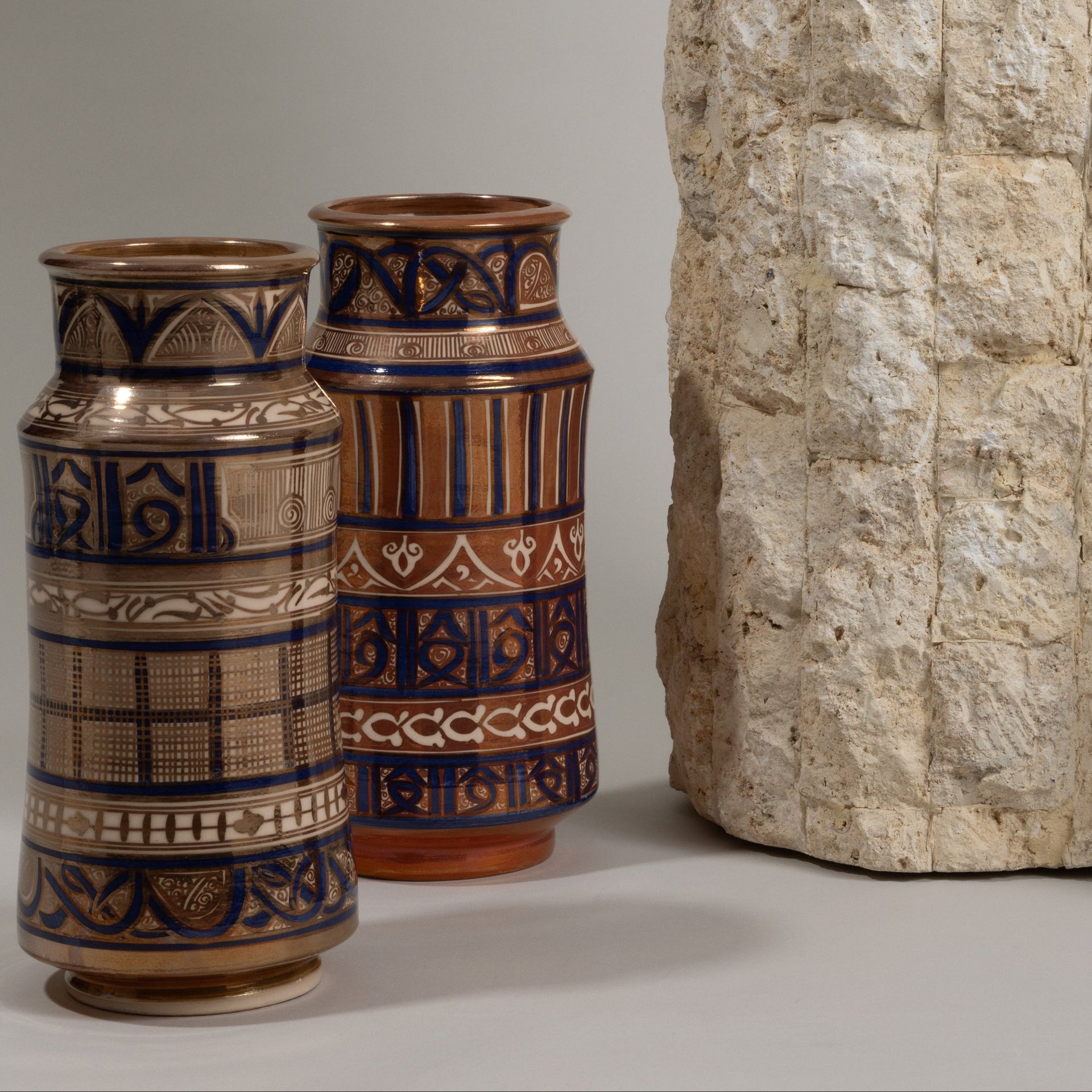 Handmade ceramic bowls, plates, and vases with tin glaze and lustreware finish.