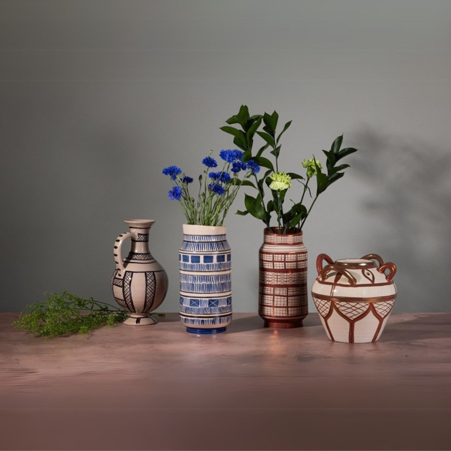 Handmade ceramic flower vases with tin glaze and lustreware, for single stems or wild floral arrangements.
