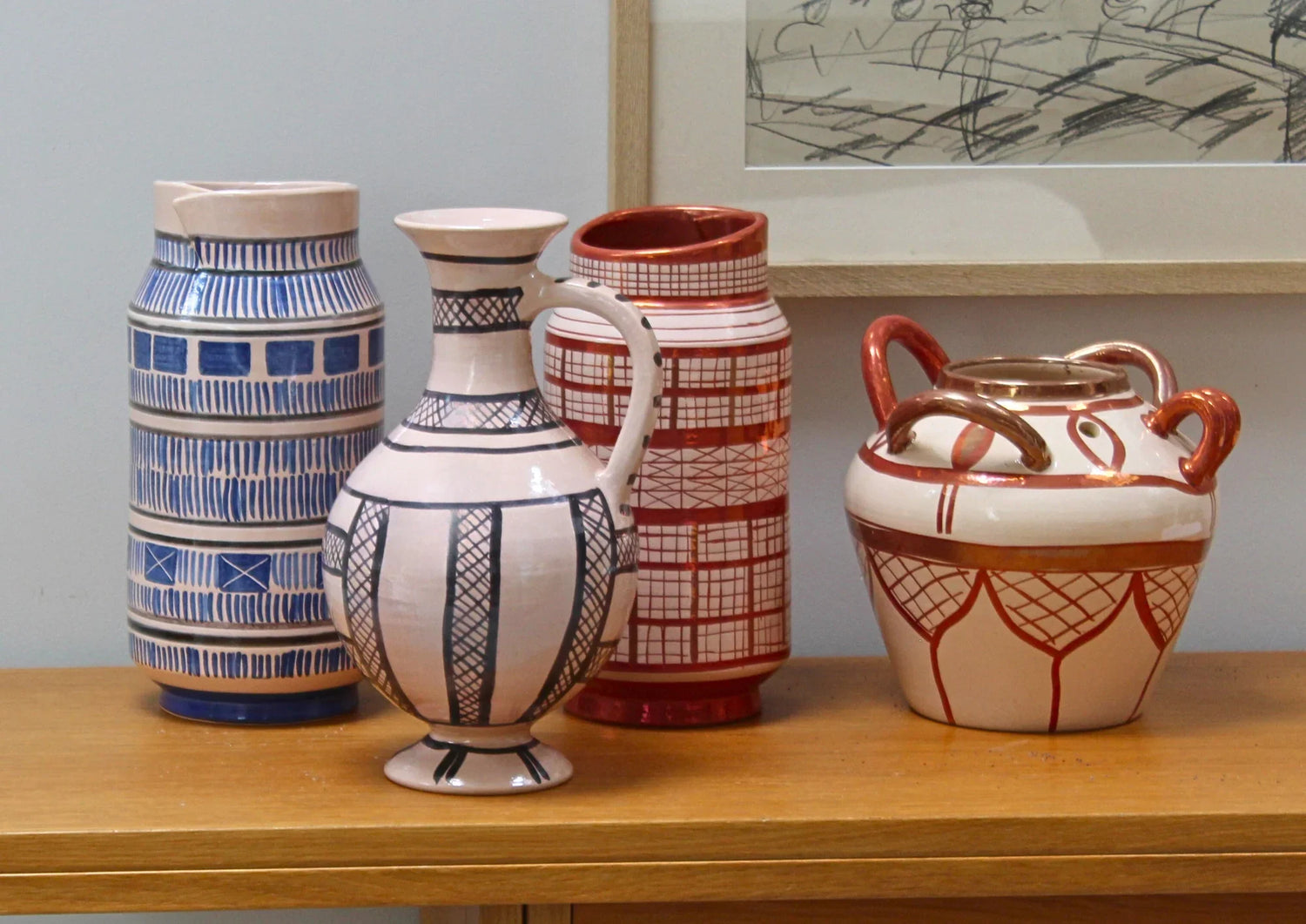 Handmade ceramic bowls, plates, and vases with tin glaze and lustreware finish.