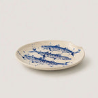 Ceramic plate with blue fish design on a white background