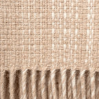 Close-up of woven throw blanket with a ribbed texture in vanilla and beige colours