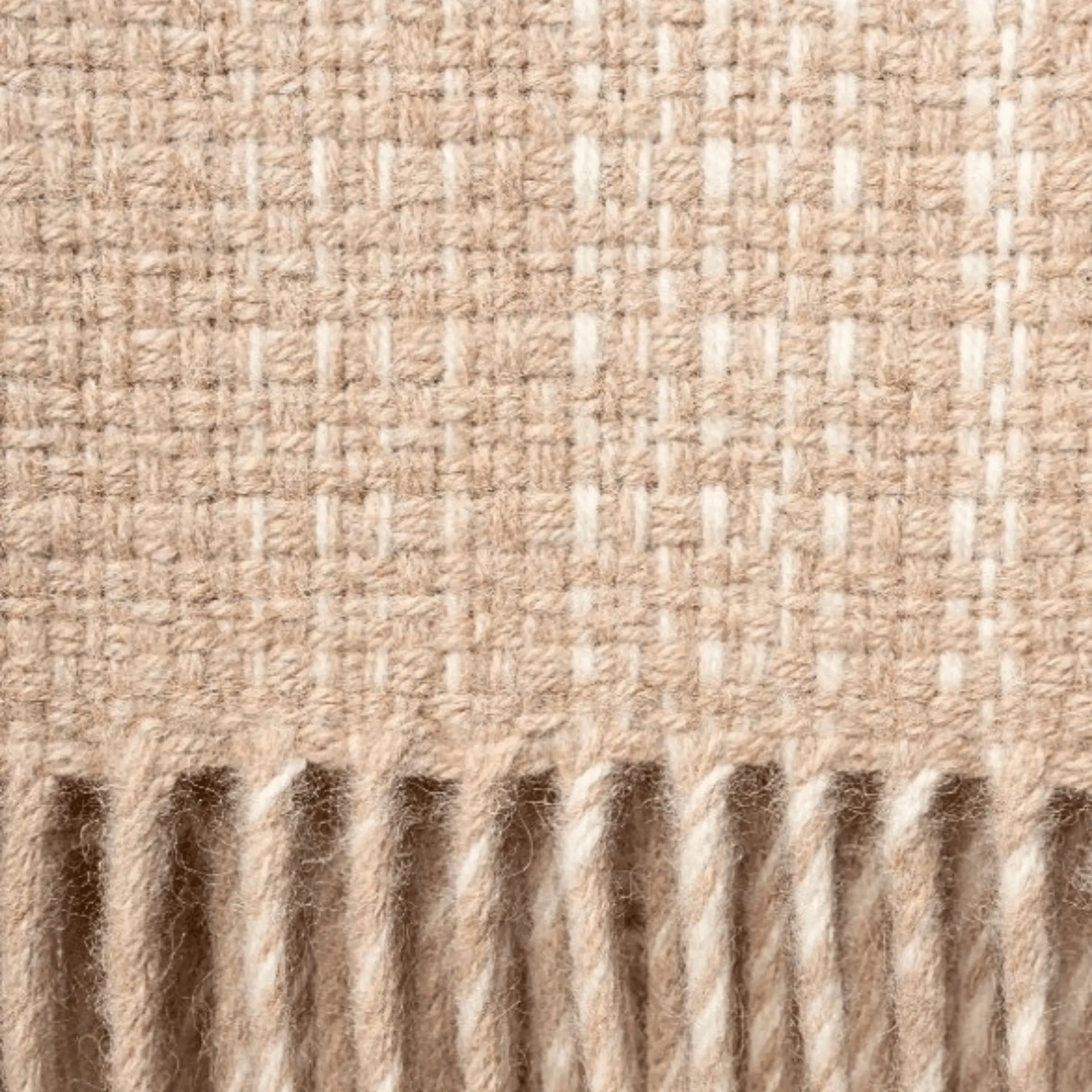 Close-up of woven throw blanket with a ribbed texture in vanilla and beige colours