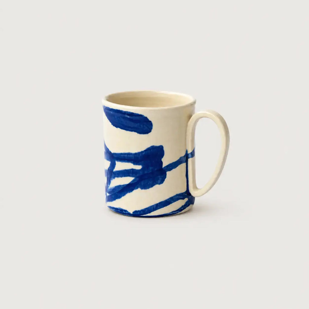 Porcelain mug with blue abstract design on a white background