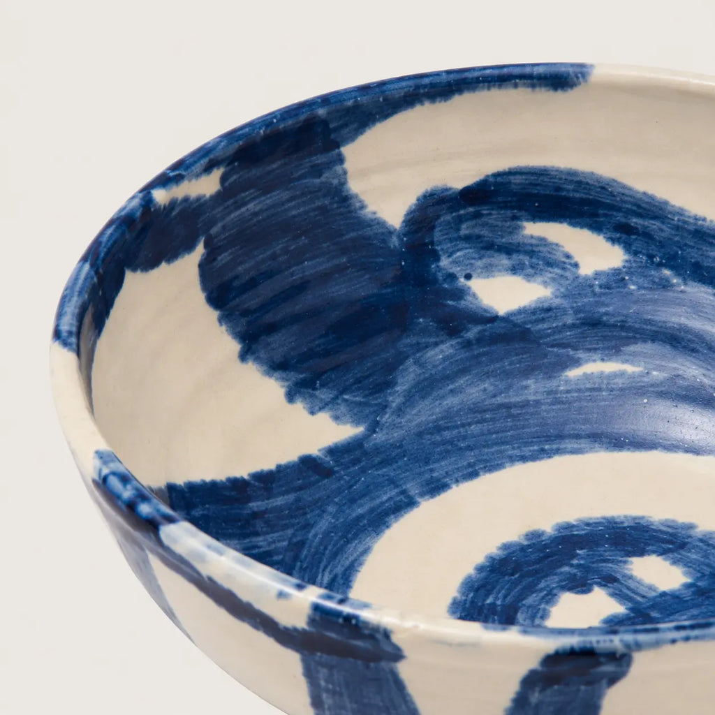 Ceramic snack bowl with blue abstract patterns on a white background