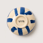 Ceramic snack bowl with blue abstract patterns on a white background, featuring the Cardoon Studio logo.