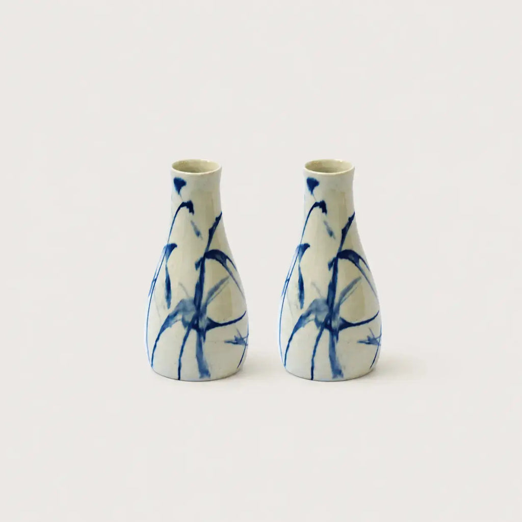 Two ceramic vases with blue abstract patterns on a white background