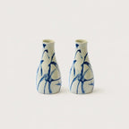 Two ceramic vases with blue abstract patterns on a white background