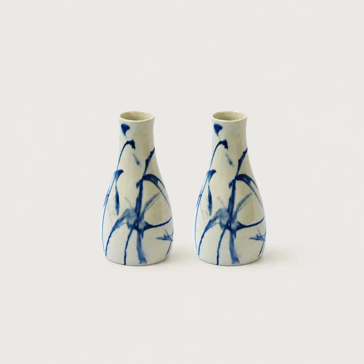 Two ceramic vases with blue abstract patterns on a white background