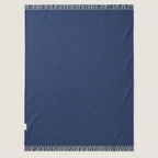 blue textured wool throw blanket laid wide on the floor