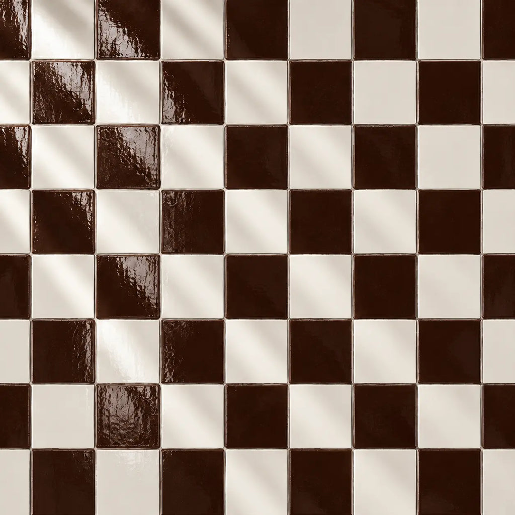 A stack of glossy square ceramic tiles in a deep chocolate brown colour, arranged on a textured off-white surface.