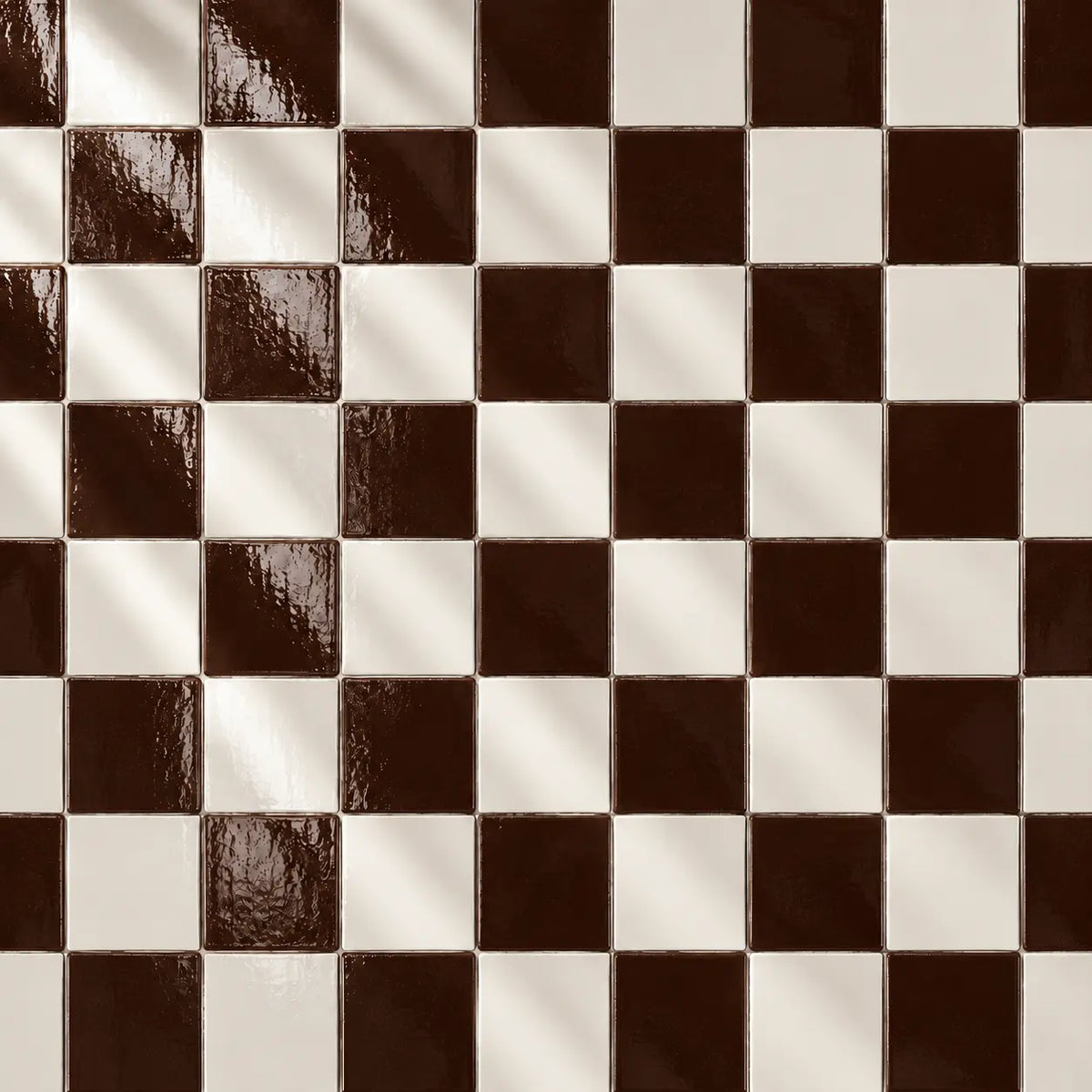 A stack of glossy square ceramic tiles in a deep chocolate brown colour, arranged on a textured off-white surface.