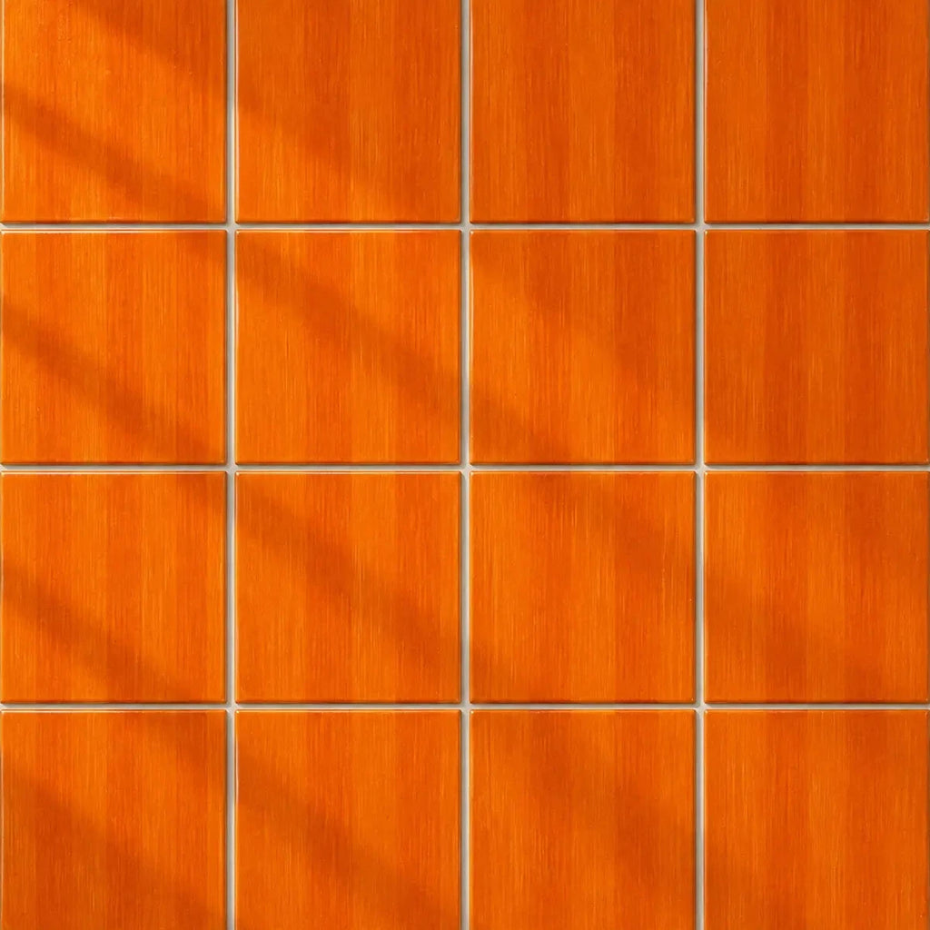 A 4x4 grid of square orange wood-look panels with a brushed texture and thin grout lines, arranged in a clean pattern with soft diagonal shadows.