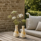 2 yellow vases on a table, terrace/ garden