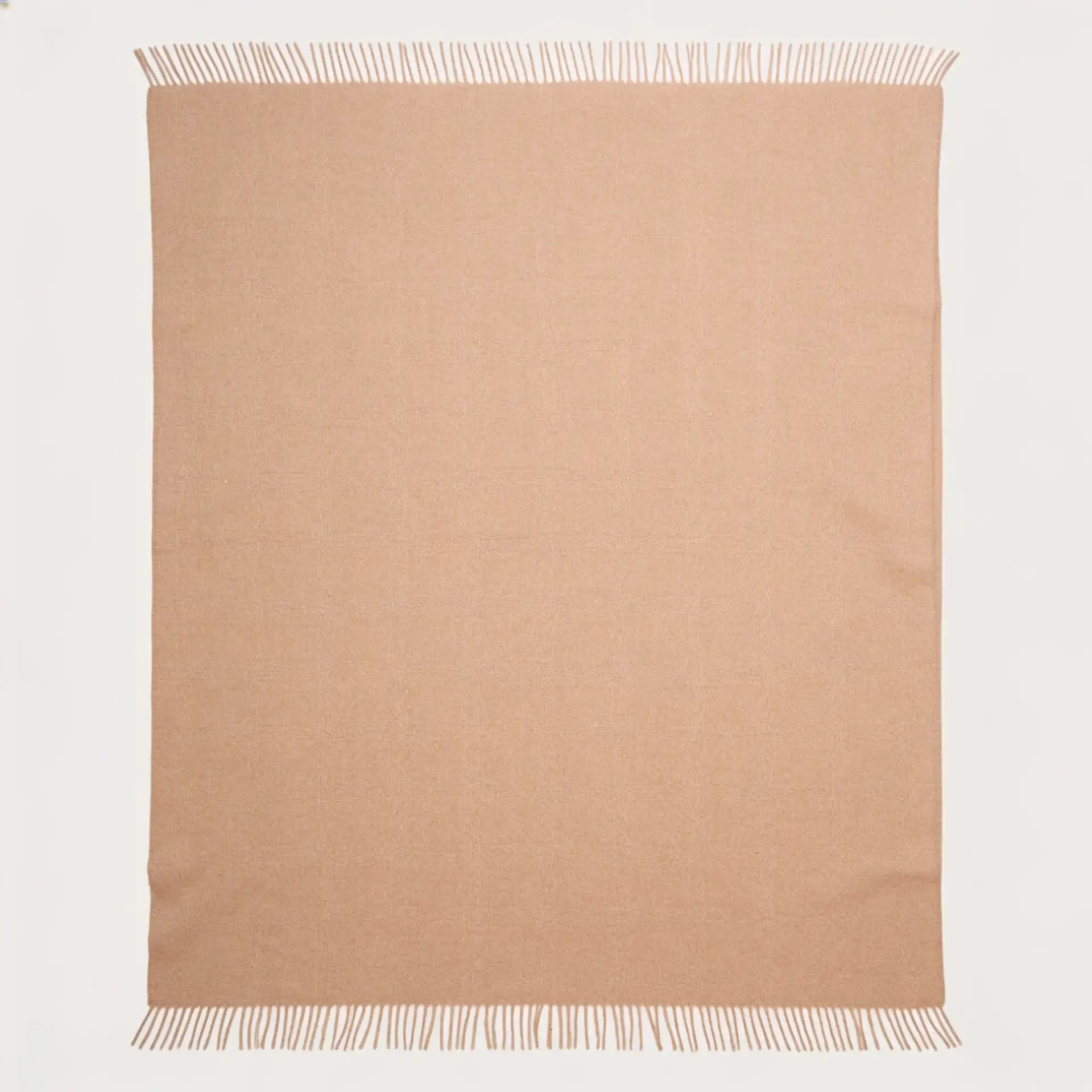 A rectangular beige alpaca throw blanket with fringed edges, laid flat against a clean white background.