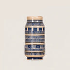 A ceramic lidded vase with a blue and beige hand-painted pattern, centered against a solid light beige background.
