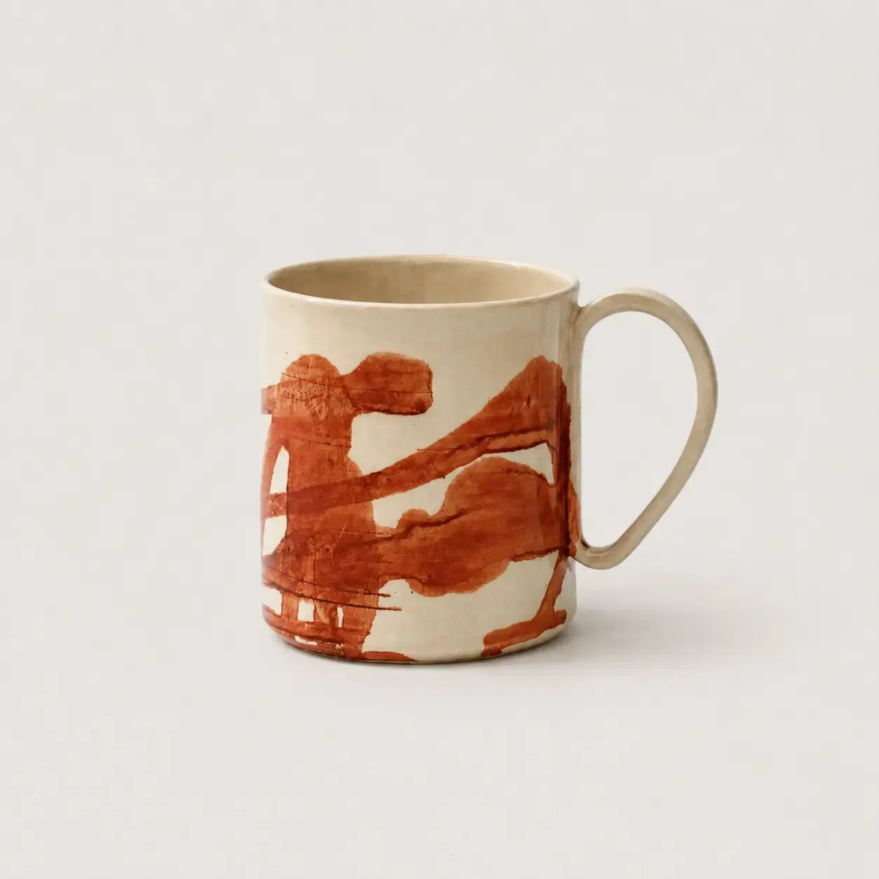 Porcelain mug with brown abstract design on a light gray background