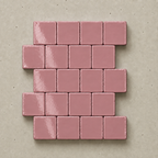 A set of glossy, rectangular dusty pink tiles arranged in a staggered brick pattern on a textured beige background.