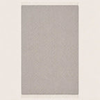 A rectangular throw blanket with a light gray and white textured herringbone pattern and white fringe on the top and bottom edges, shown against a plain off-white background.