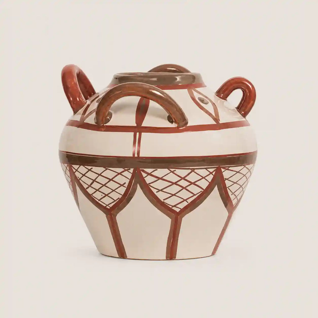 A ceramic lidded pot with two loop handles, decorated with a brown geometric pattern on an off-white glaze, set against a solid light beige background.