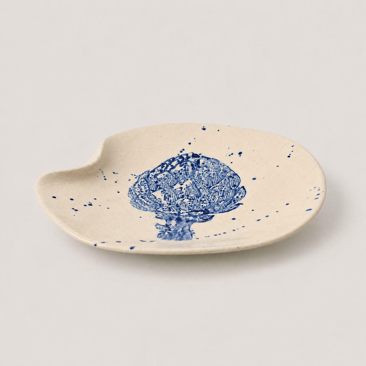 Ceramic dish with blue floral design on a beige background