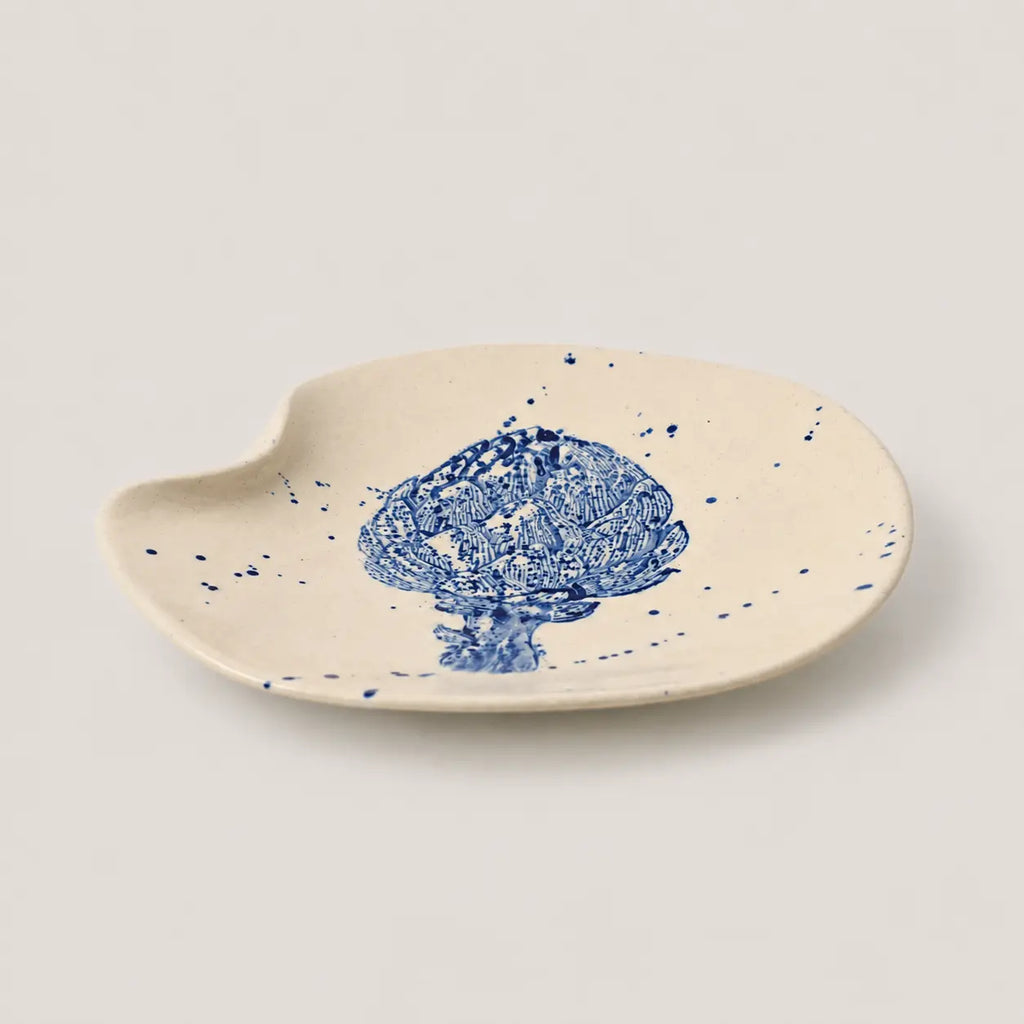 Ceramic dish with blue floral design on a beige background