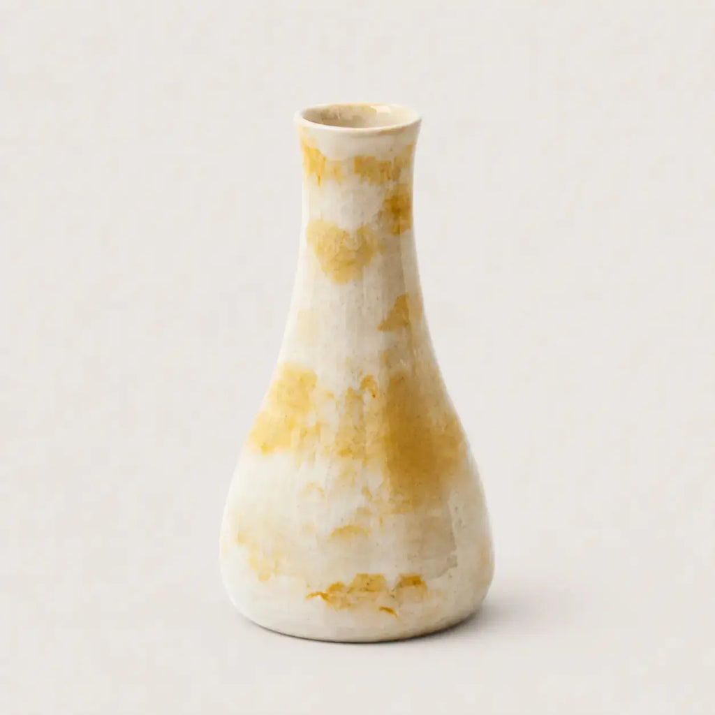 White vase with yellow marbled pattern on a light gray background