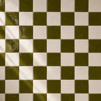 Moss green and white ceramic tiles in checkerboard pattern