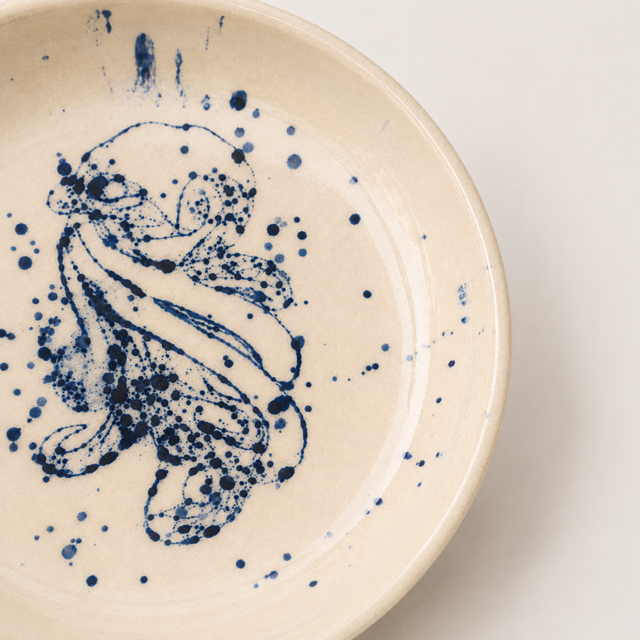 Close-up of hand-painted cobalt blue octopus on Octavia plate