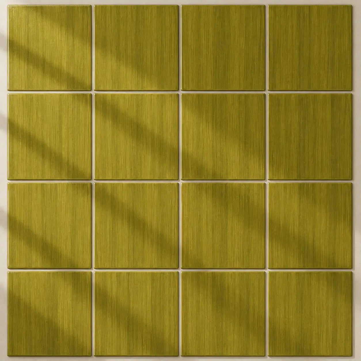 A 3x5 grid of square tiles in a warm olive-yellow or moss green color with a brushed texture, arranged on a light beige background with soft diagonal shadows.