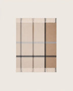 A rectangular woven throw blanket with a classic check pattern in beige, tan, brown, and gray, featuring fringed edges on all sides, shown flat against a light off-white background.