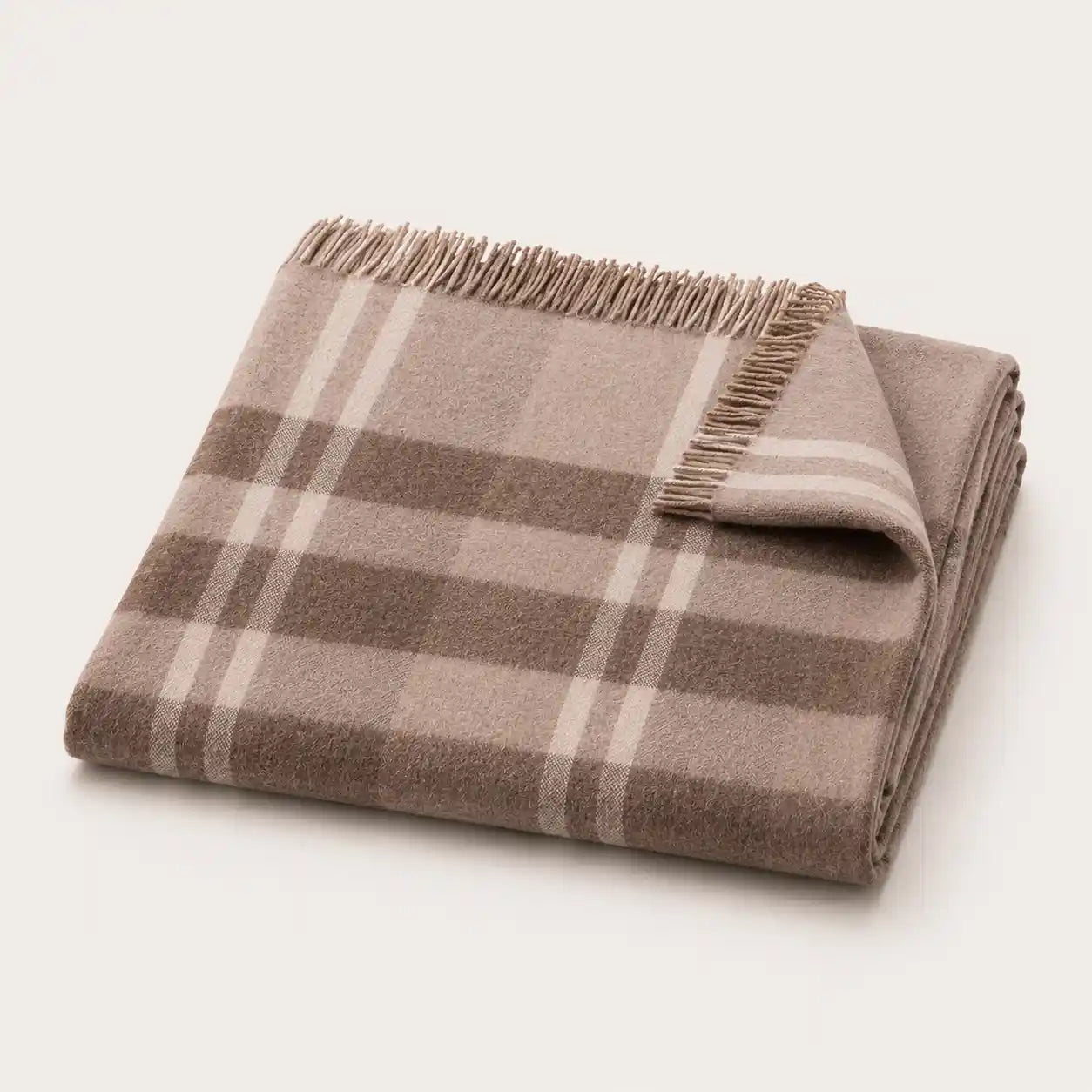 A folded plaid throw blanket with fringed edges, shown on a clean off-white background. The pattern features shades of taupe, brown, and cream.