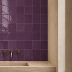 Plum glossy ceramic tiles used on a bathroom wall