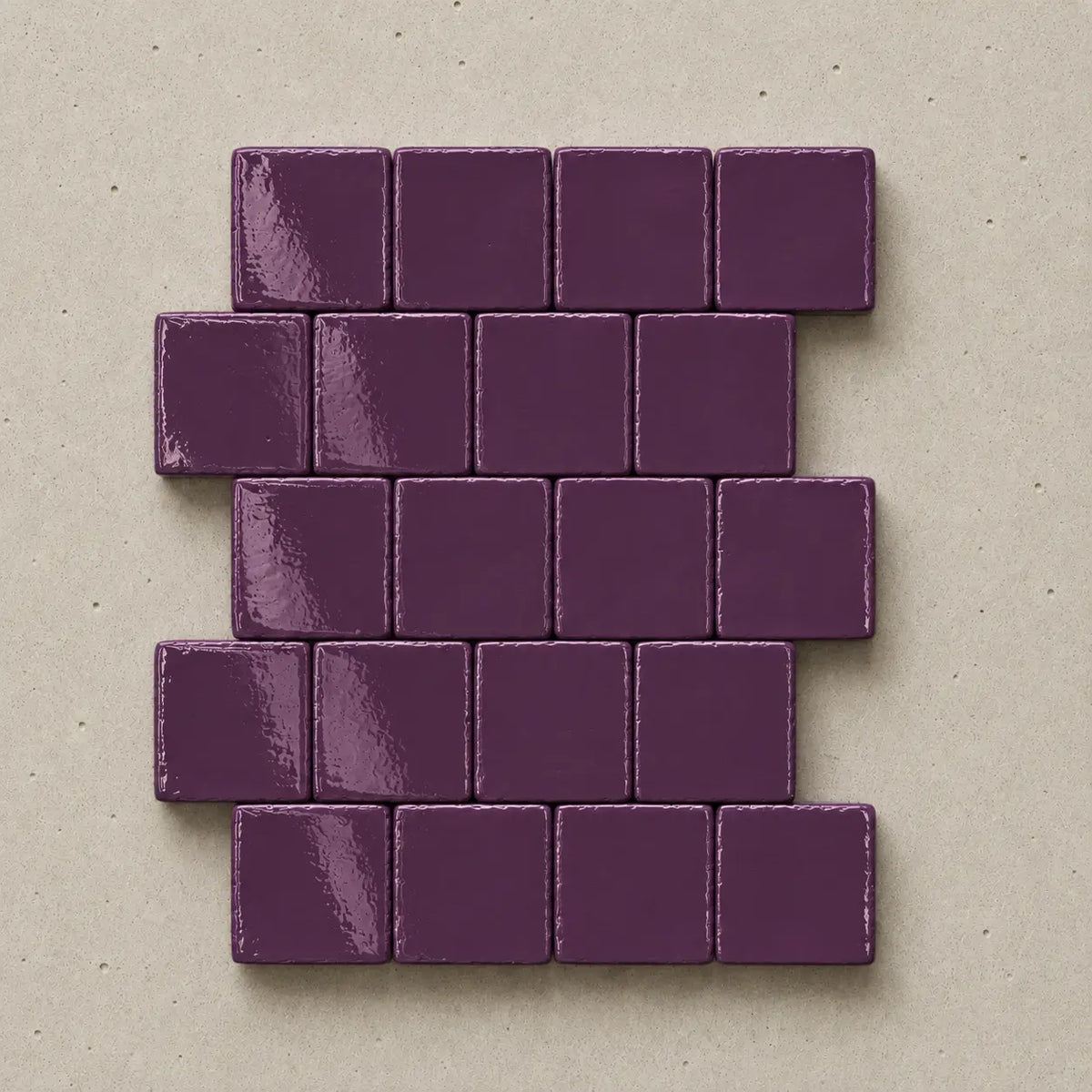 Handmade plum ceramic tiles showing natural variation