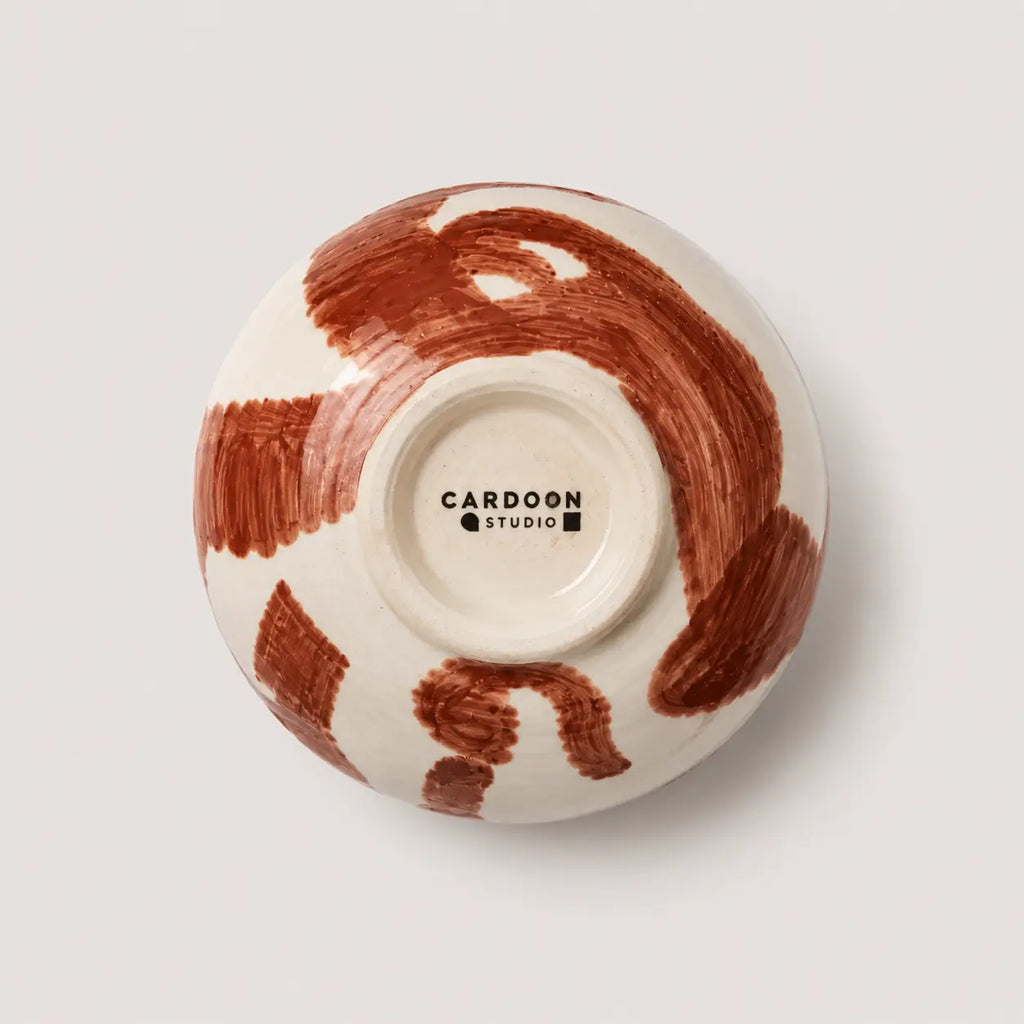 Ceramic snack bowl with brown abstract design on a white background, featuring the Cardoon Studio logo.