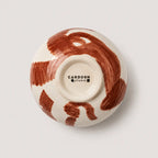 Ceramic snack bowl with brown abstract design on a white background, featuring the Cardoon Studio logo.