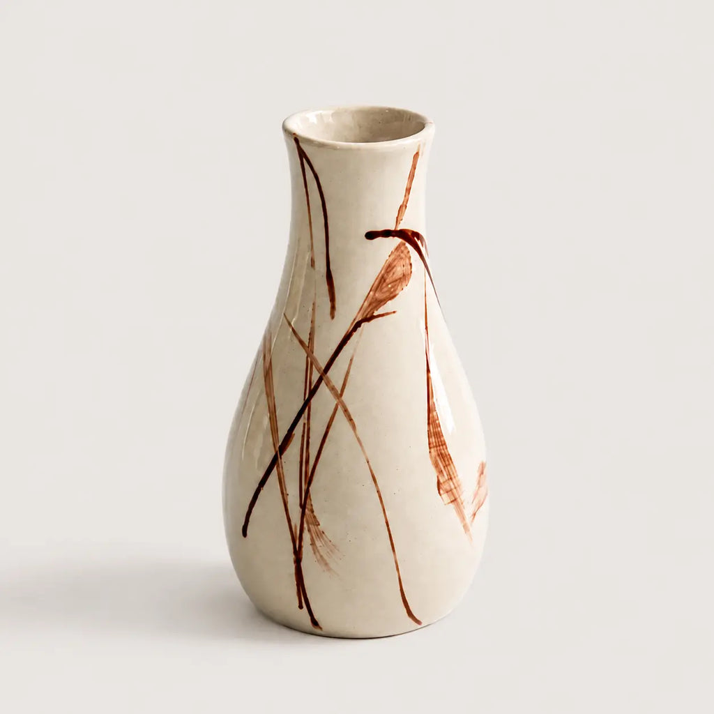 Ceramic vase with brown abstract patterns on a light gray background