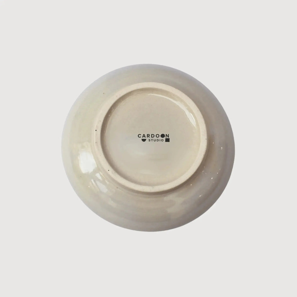 Underside of a handcrafted ceramic plate showing the Cardoon Studio stamp and smooth glazed finish.