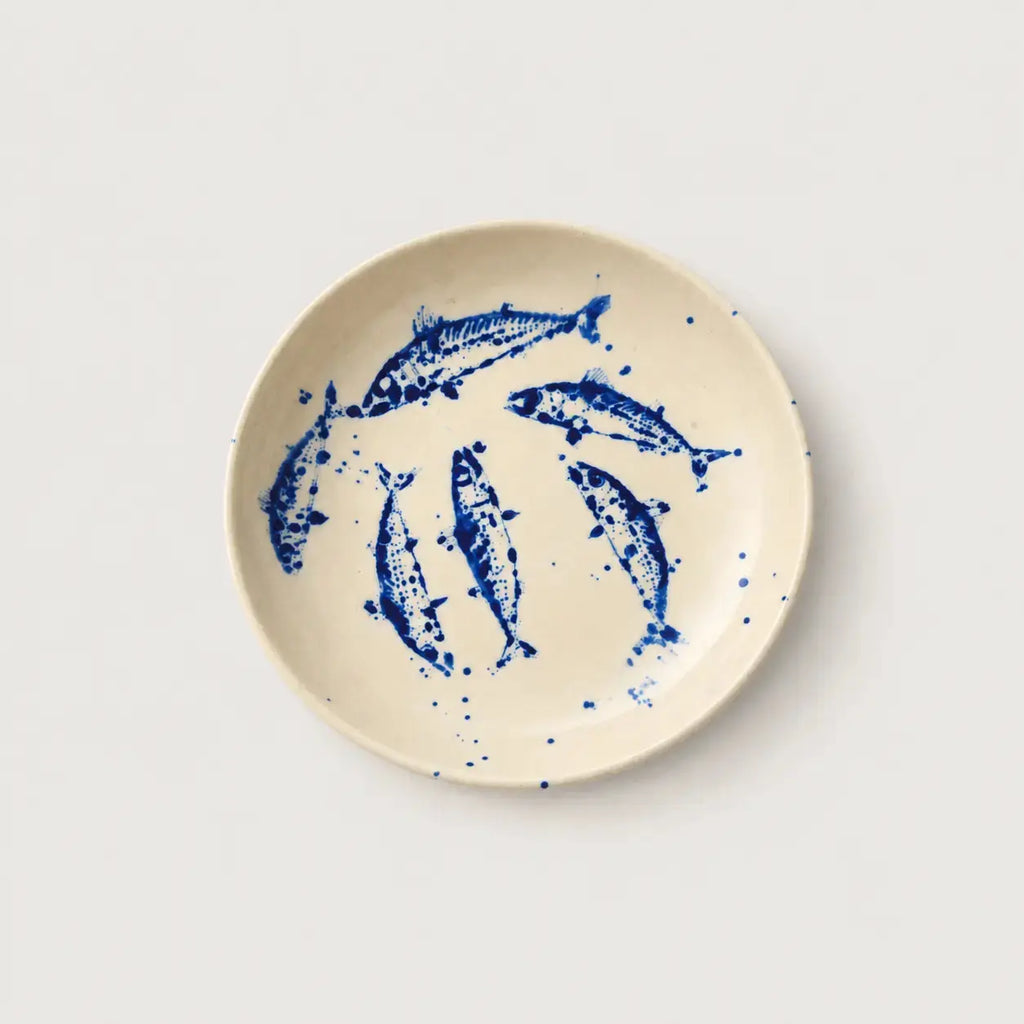 Ceramic plate with blue fish design on a white background
