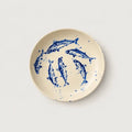 Ceramic plate with blue fish design on a white background