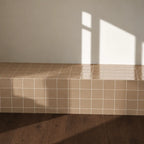 Sand colour ceramic tiles used on an interior wall