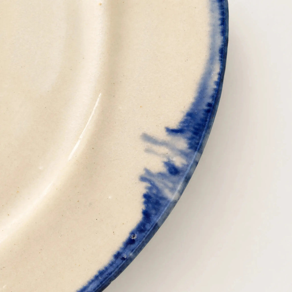 Close-up of hand-painted cobalt blue rim on Shoreline stoneware plate