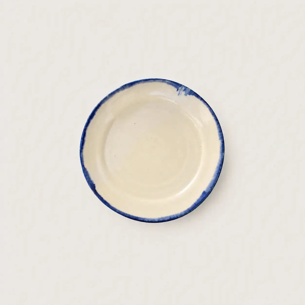 Close-up of hand-painted cobalt blue rim on Shoreline stoneware plate
