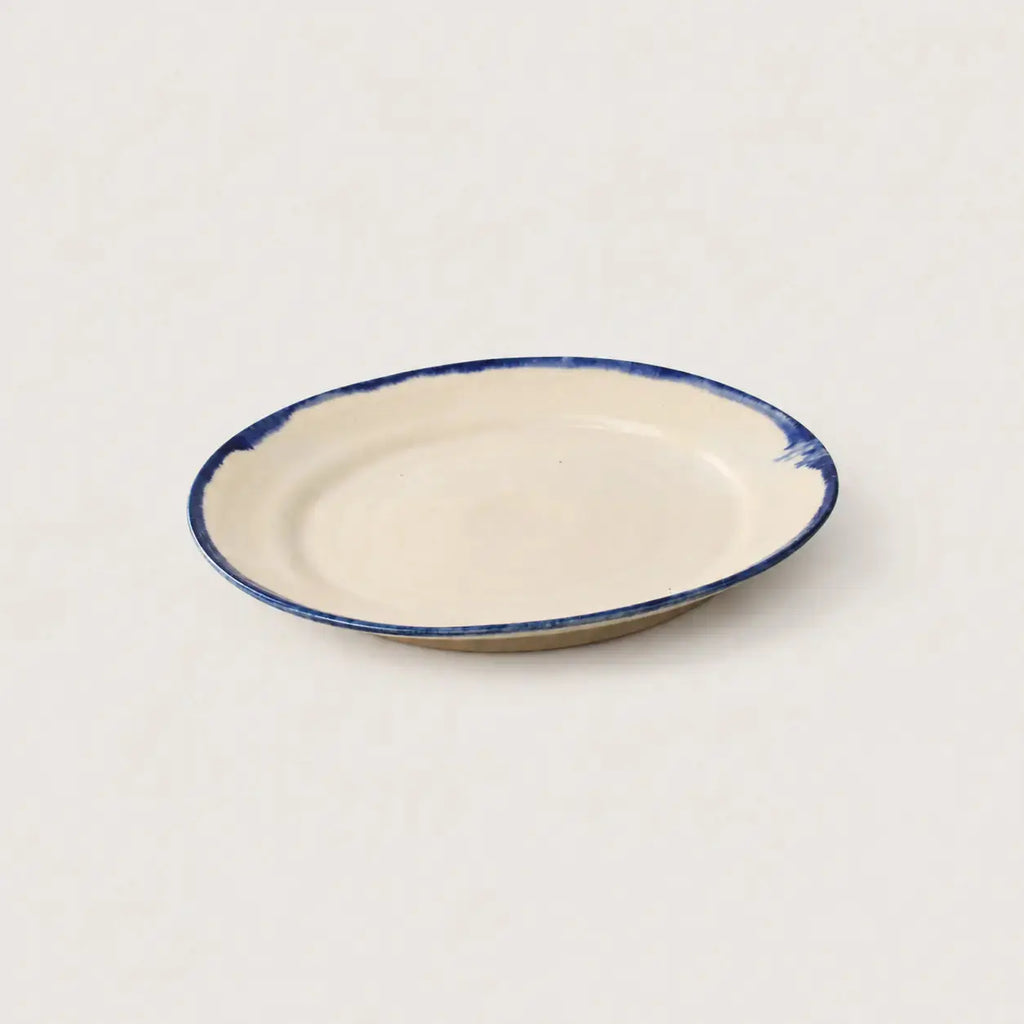 Side view of Shoreline handmade stoneware plate showing organic profile.