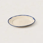 Side view of Shoreline handmade stoneware plate showing organic profile.