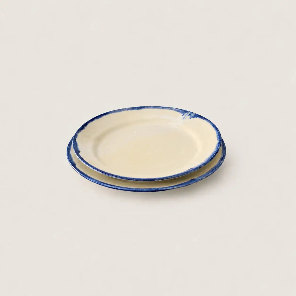 Shoreline cream stoneware side plate with hand-painted blue rim