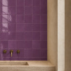 Violet gloss ceramic tiles used on a bathroom wall