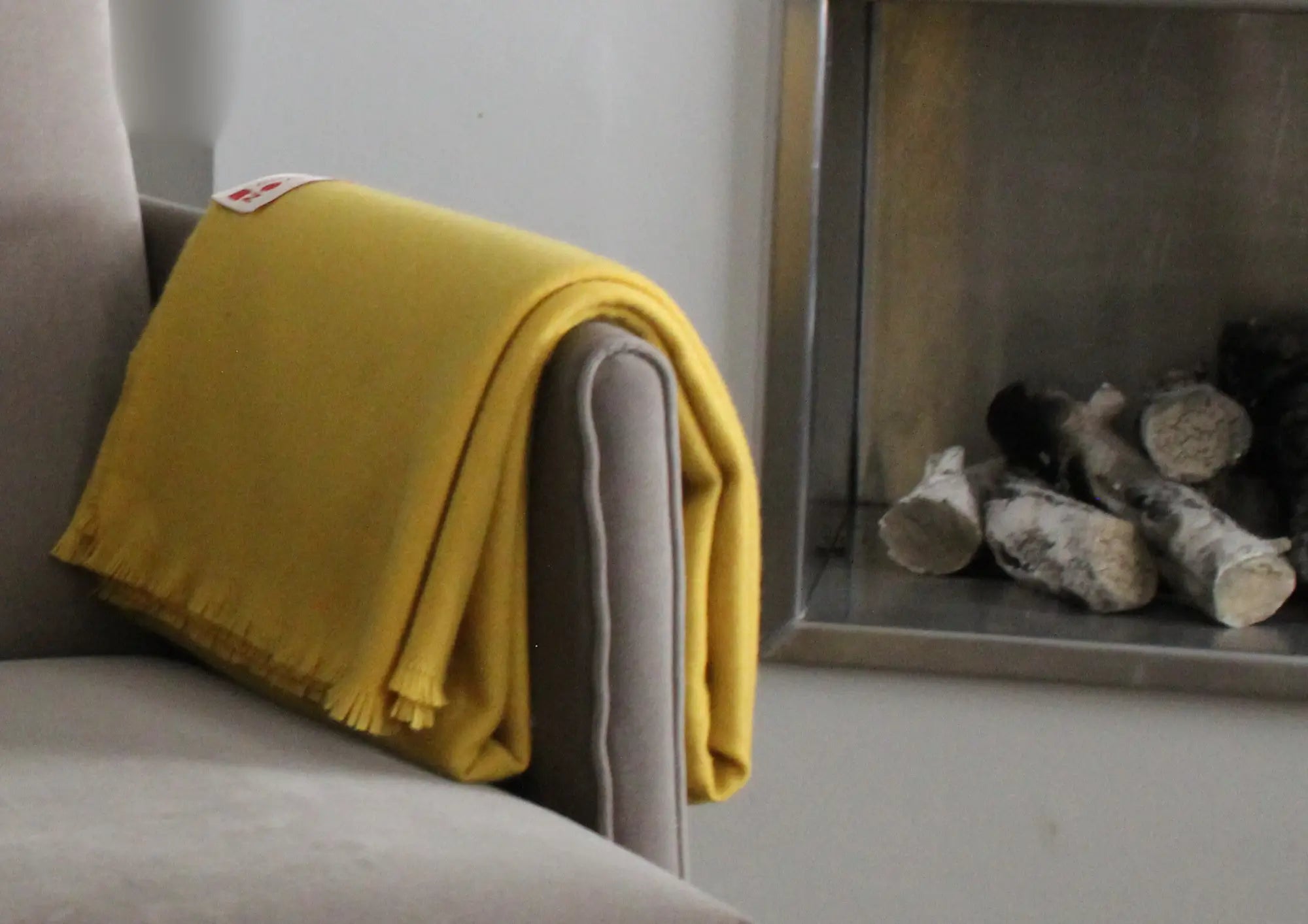 Cardoon Studio soft yellow throw blanket with fringed edges, designed for cozy interiors and modern home décor.